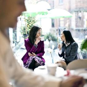 Women in meeting drinking coffee